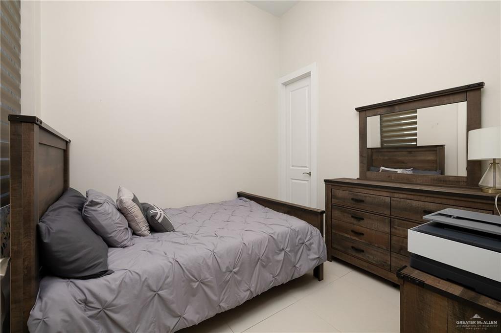 4401 South L Street McAllen, TX 78503 - Photo 17 of 20 a bedroom with a bed and a flat screen tv