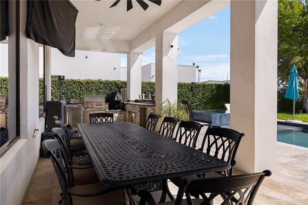 4401 South L Street McAllen, TX 78503 - Photo 19 of 20 a view of a patio with table and chairs with wooden floor and fence