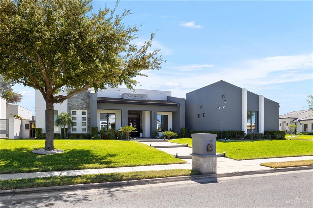 4401 South L Street McAllen, TX 78503 - Photo 2 of 20 a view of a house with a big yard plants and large trees