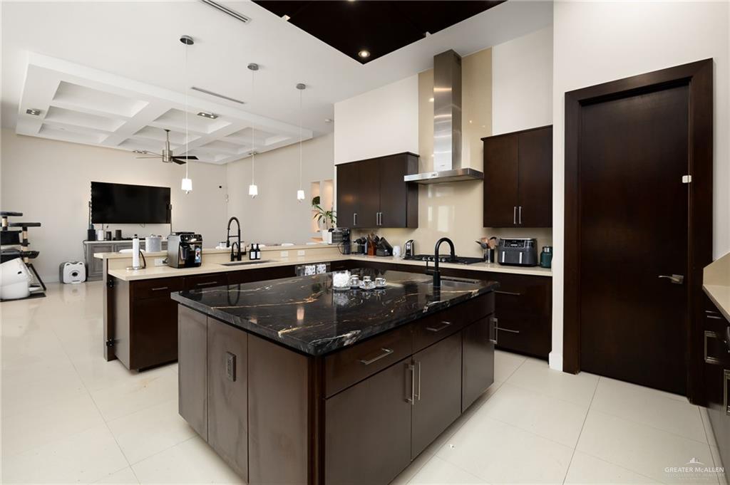 4401 South L Street McAllen, TX 78503 - Photo 7 of 20 a kitchen with stainless steel appliances granite countertop a sink stove and refrigerator