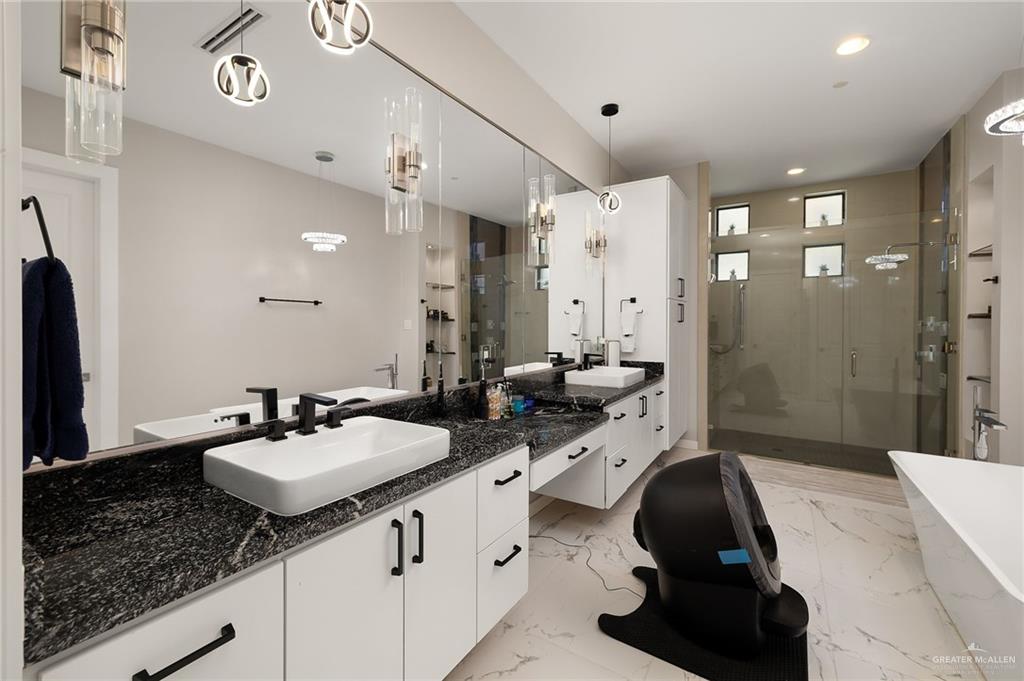 4401 South L Street McAllen, TX 78503 - Photo 10 of 20 a bathroom with a sink double vanity granite tub shower and a mirror