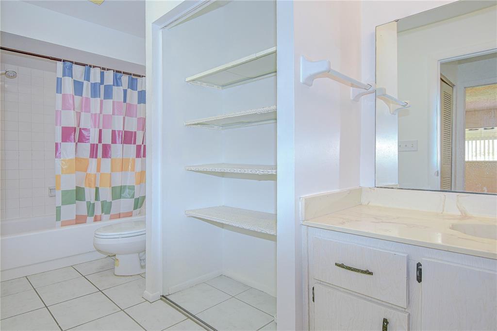 11511 113th Street, Unit 33D Largo, FL 33778 - Photo 17 of 33 a bathroom with a sink toilet vanity and shower