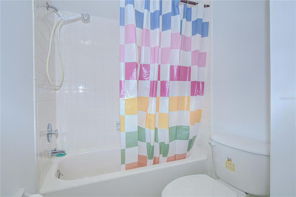 11511 113th Street, Unit 33D Largo, FL 33778 - Photo 19 of 33 a bathroom with a bathtub and shower