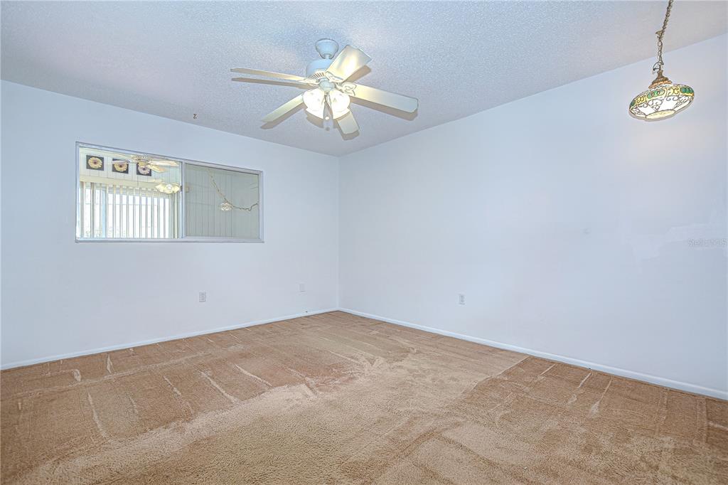 11511 113th Street, Unit 33D Largo, FL 33778 - Photo 20 of 33 an empty room with windows and fan