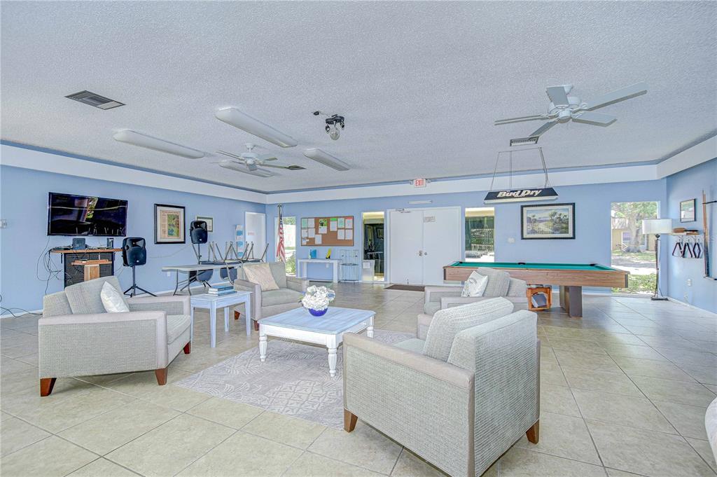 11511 113th Street, Unit 33D Largo, FL 33778 - Photo 31 of 33 a living room with furniture and a flat screen tv