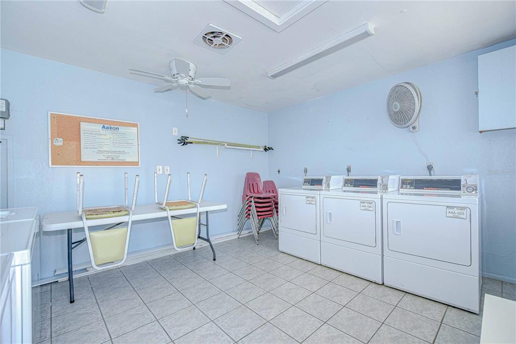 11511 113th Street, Unit 33D Largo, FL 33778 - Photo 32 of 33 a view of kitchen with white cabinets stainless steel appliances and a window
