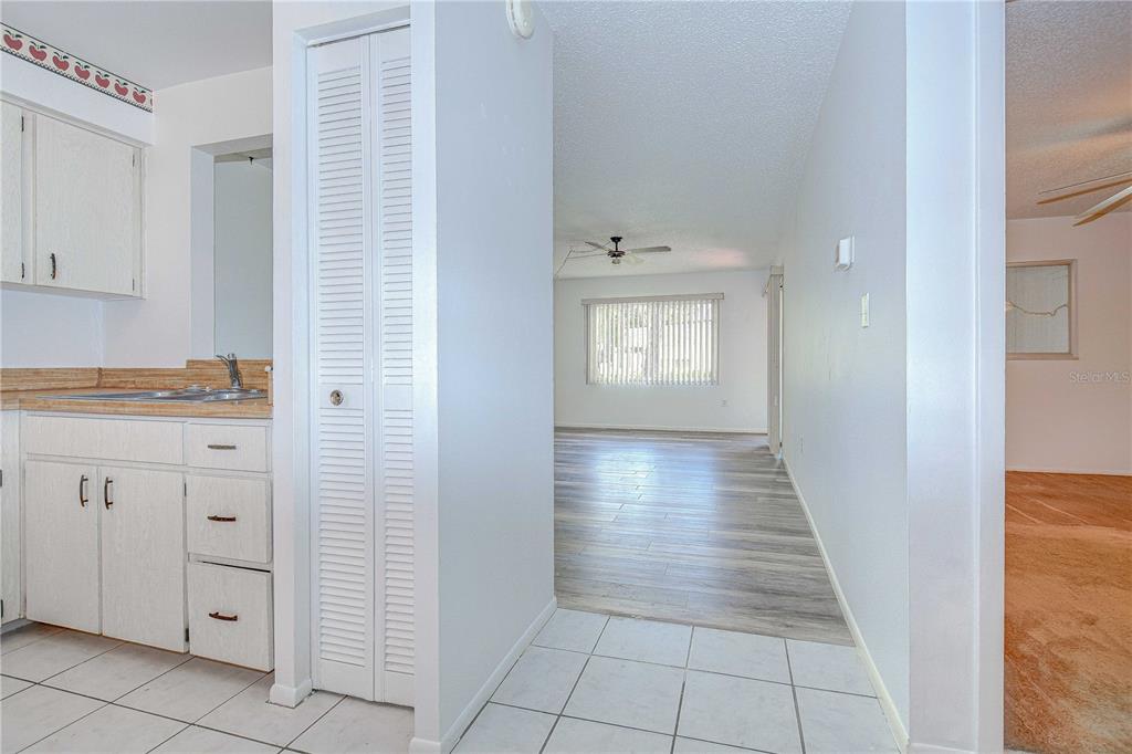 11511 113th Street, Unit 33D Largo, FL 33778 - Photo 10 of 33 a view of a hallway with closet and cabinet