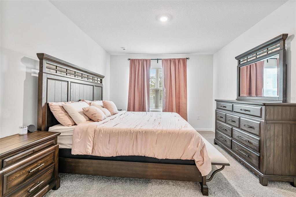 511 Baroness Way DeLand, FL 32724 - Photo 18 of 37 a bedroom with a bed and a window