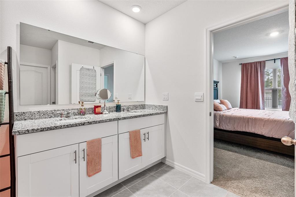 511 Baroness Way DeLand, FL 32724 - Photo 19 of 37 a en suite bathroom with sinks double vanity granite and mirror