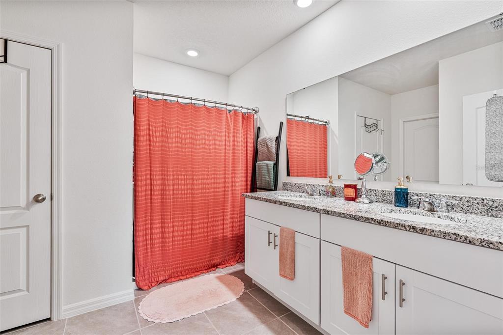 511 Baroness Way DeLand, FL 32724 - Photo 20 of 37 a bathroom with a granite countertop sink and a mirror
