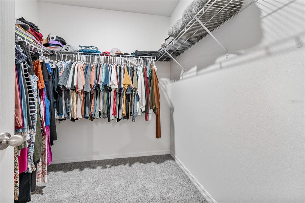 511 Baroness Way DeLand, FL 32724 - Photo 21 of 37 a view of walk in closet with clothes