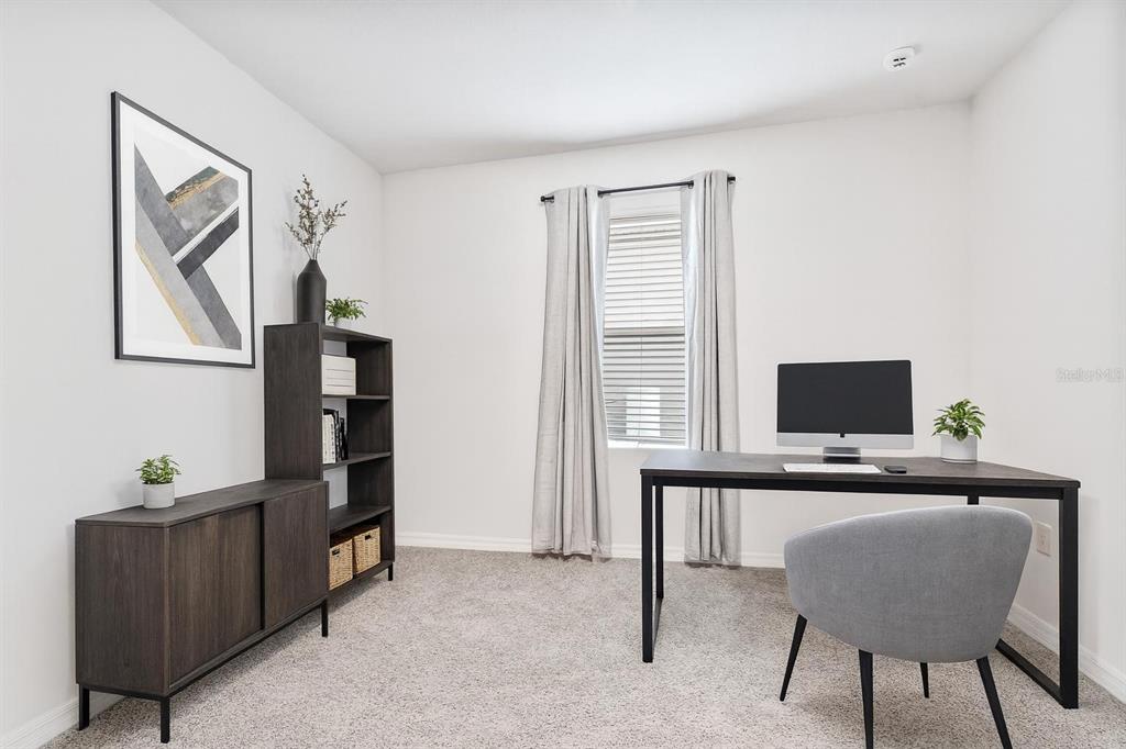 511 Baroness Way DeLand, FL 32724 - Photo 23 of 37 a view of a workspace with furniture and a window