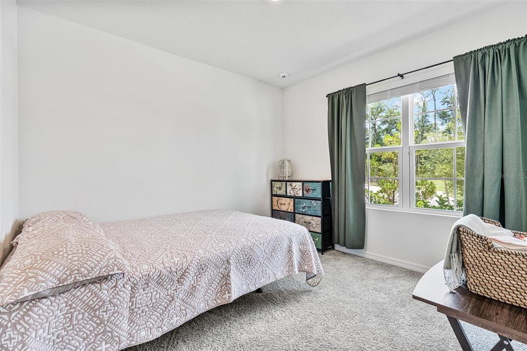 511 Baroness Way DeLand, FL 32724 - Photo 26 of 37 a bedroom with a bed chair and window