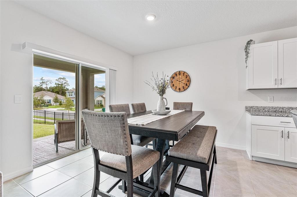 511 Baroness Way DeLand, FL 32724 - Photo 28 of 37 a view of a dining room with furniture window and outside view
