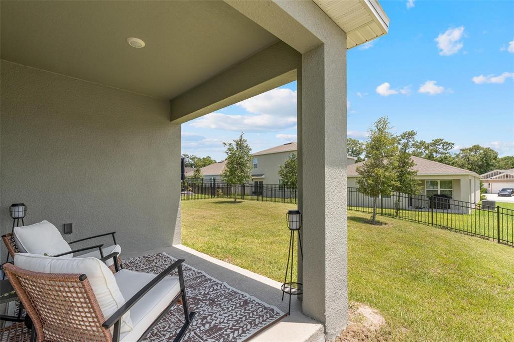 511 Baroness Way DeLand, FL 32724 - Photo 30 of 37 a view of a balcony with chair and floor to ceiling window