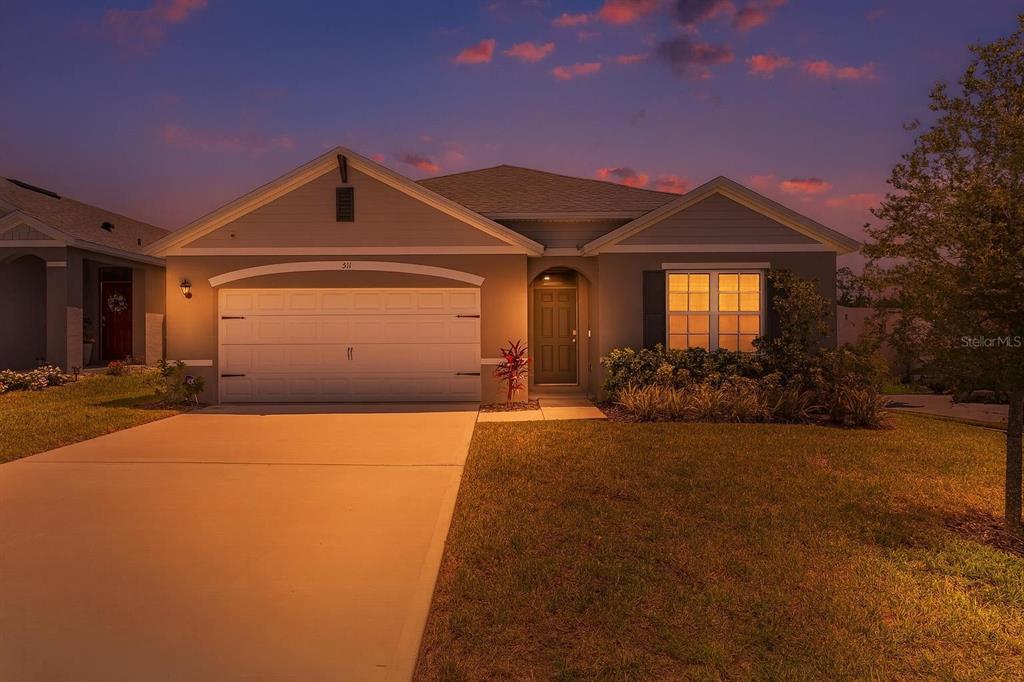511 Baroness Way DeLand, FL 32724 - Photo 32 of 37 a front view of a house with a yard and garage