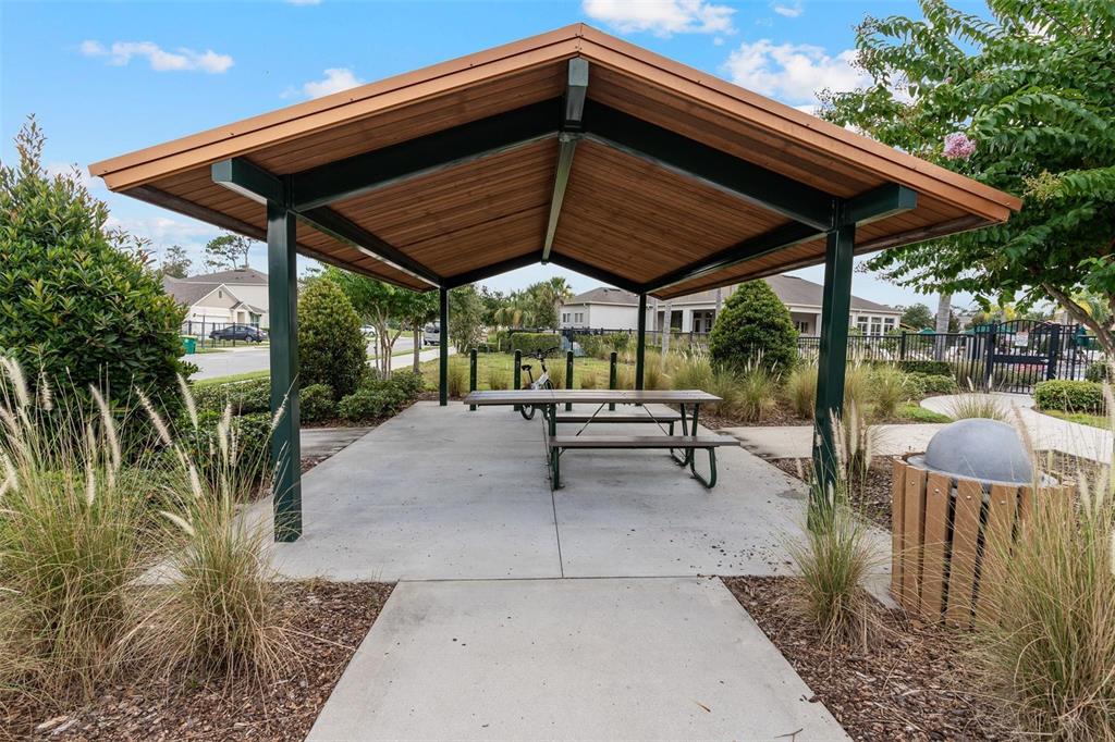 511 Baroness Way DeLand, FL 32724 - Photo 34 of 37 a view of patio with table and chairs under an umbrella with a small yard