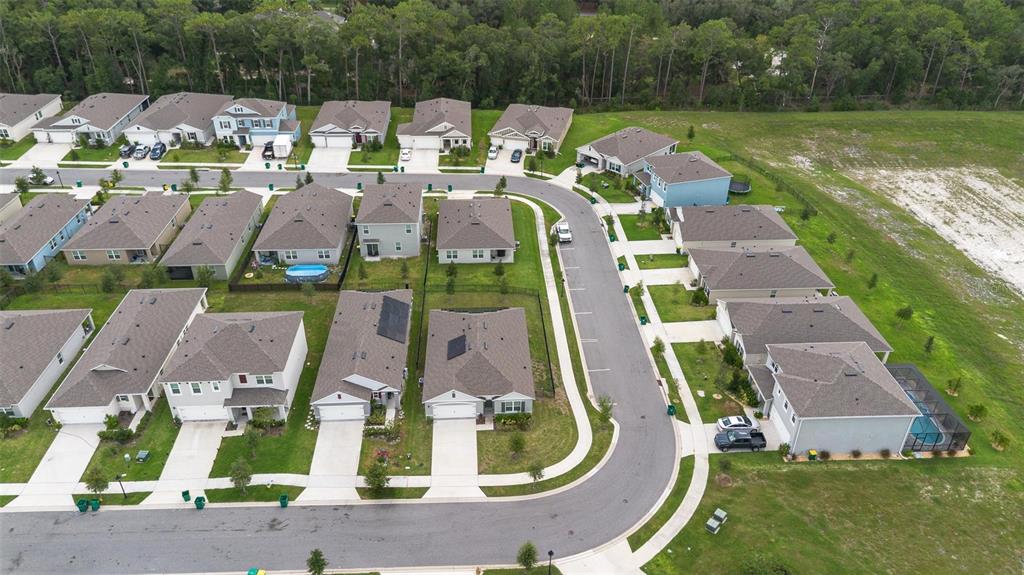 511 Baroness Way DeLand, FL 32724 - Photo 4 of 37 an aerial view of a house with a garden and lake view
