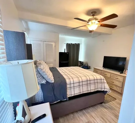 a bedroom with a bed and a flat screen tv