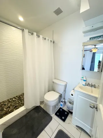 a bathroom with a sink toilet and shower