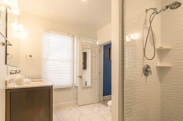 a bathroom with a bathtub and a shower