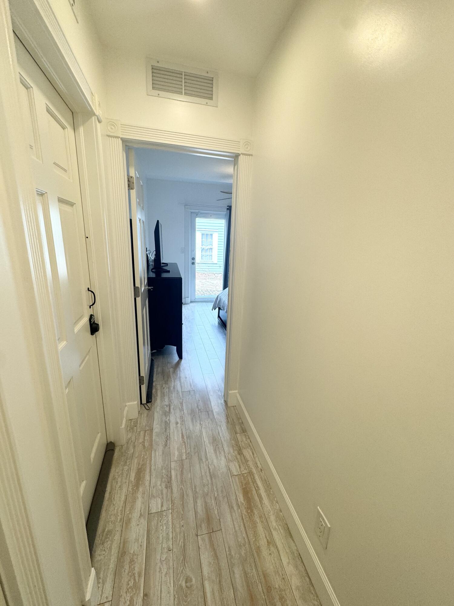 1207 William Street, Unit 3 Key West, FL 33040 - Photo 6 of 20 a view of a hallway with wooden floor and a bathroom