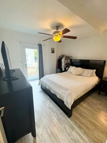 a bedroom with a bed dresser and a window