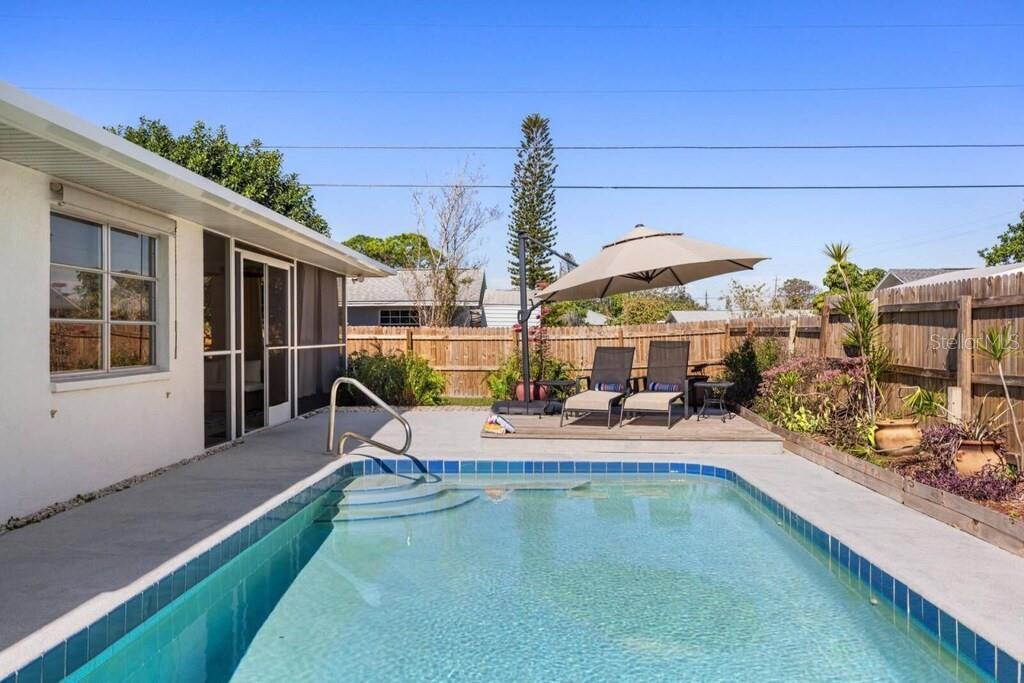 4731 Egret Road Venice, FL 34293 - Photo 27 of 34 a view of a house with swimming pool and sitting area