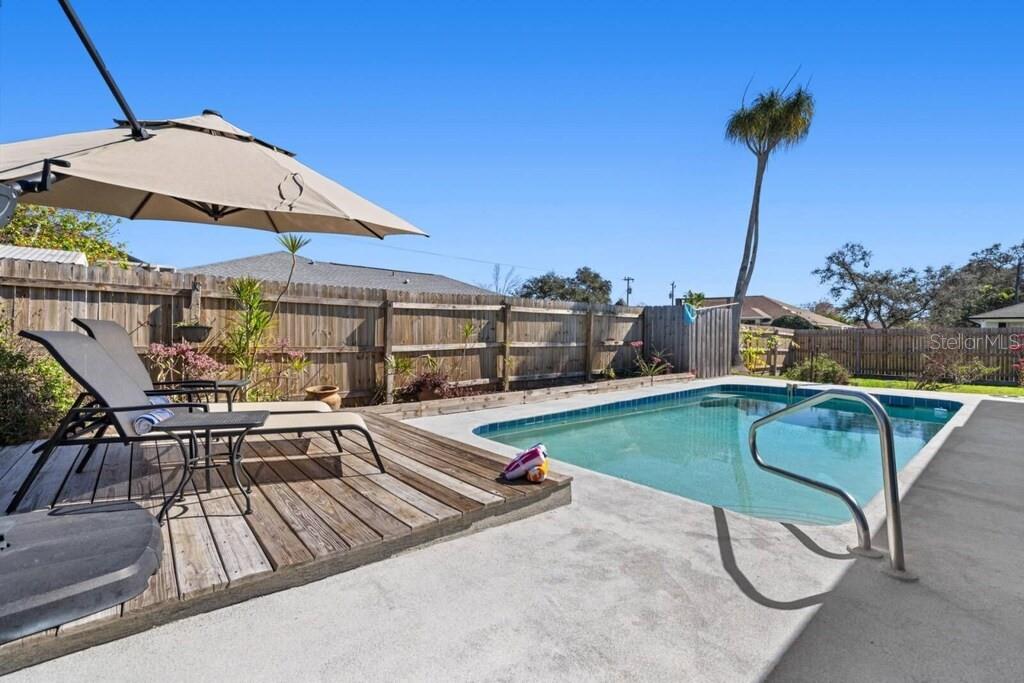 4731 Egret Road Venice, FL 34293 - Photo 30 of 34 a view of a swimming pool with a lounge chairs