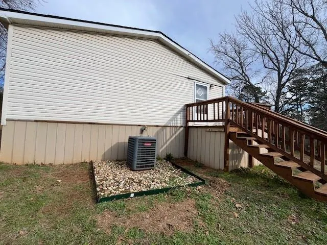 a wooden bench sitting in front of a house
