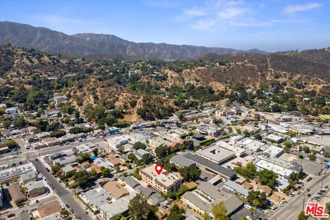 an aerial view of residential houses with city view