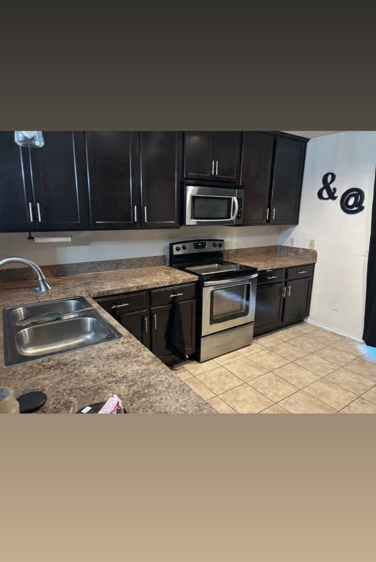 9534 Brandon Rock Lane Houston, TX 77044 - Photo 5 of 7 a kitchen with a stove and a sink
