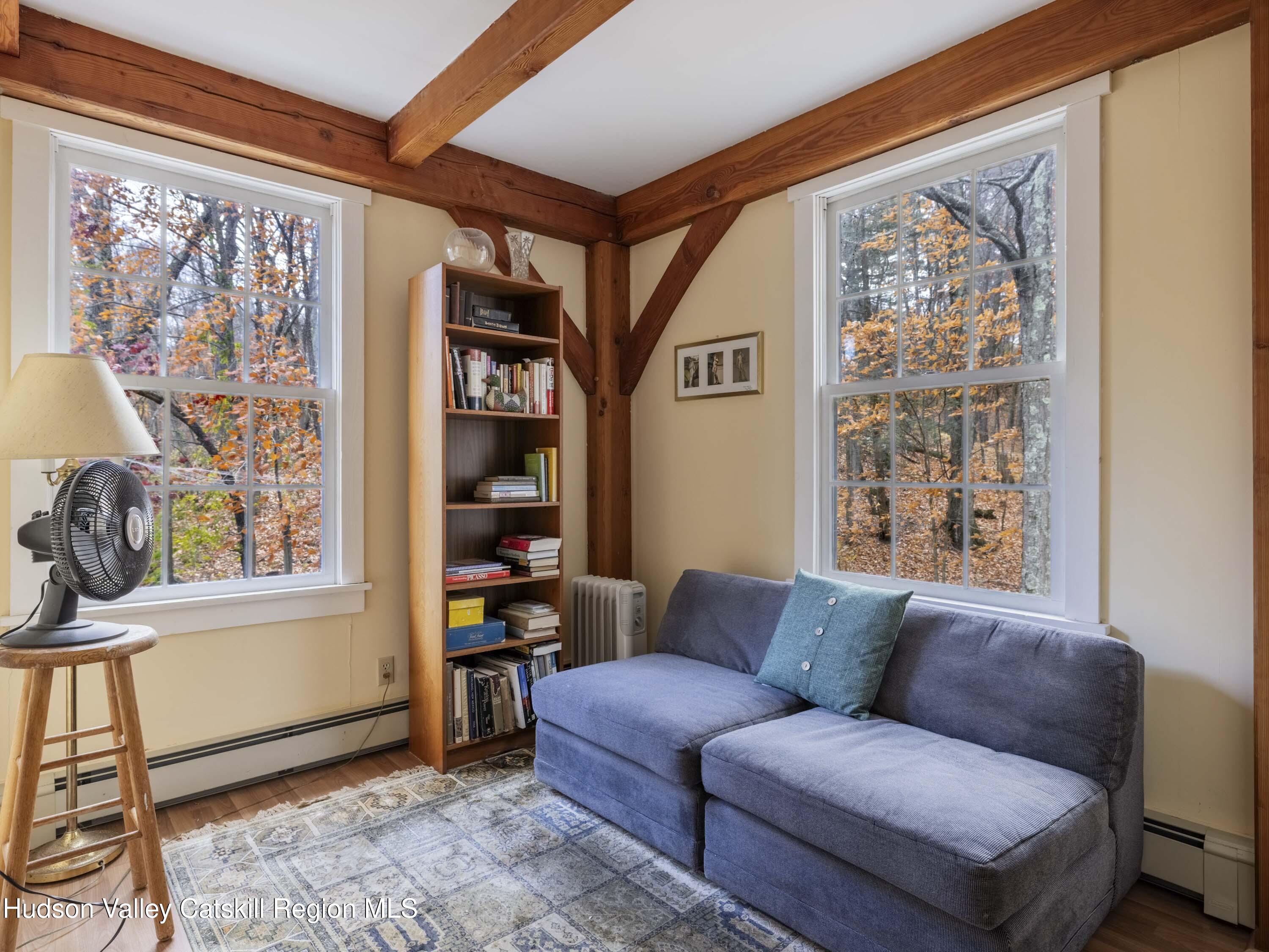216 Starbarrack Road Red Hook, NY 12571 - Photo 33 of 45 a living room with furniture a window and a bookshelf