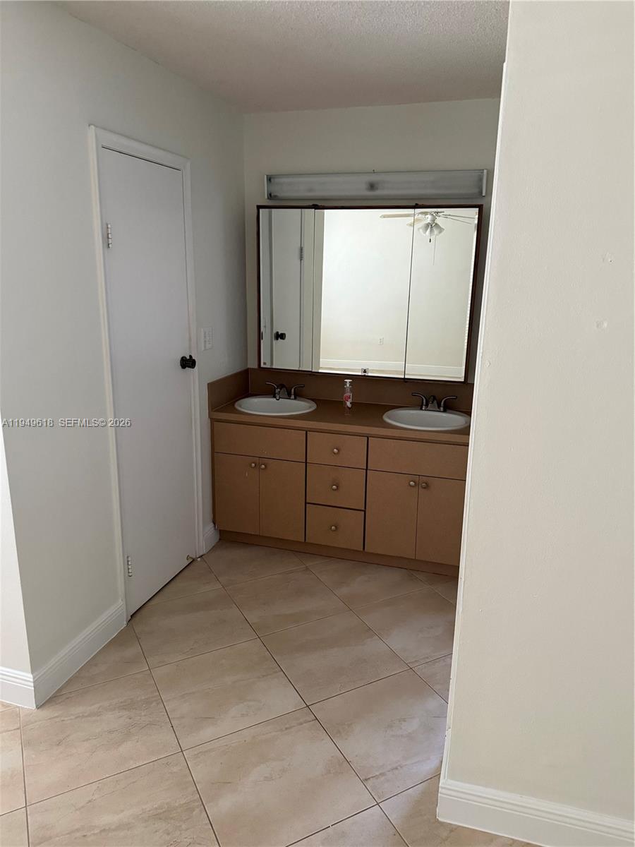 2431 Southwest 124th Avenue Miami, FL 33175 - Photo 15 of 20 a bathroom with a sink and a mirror
