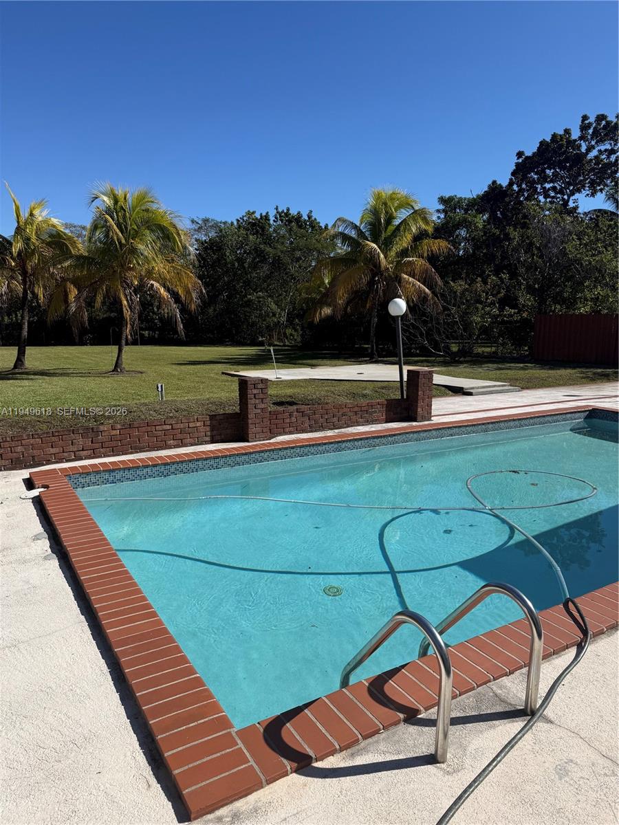 2431 Southwest 124th Avenue Miami, FL 33175 - Photo 6 of 20 a view of a swimming pool with a yard and sitting area