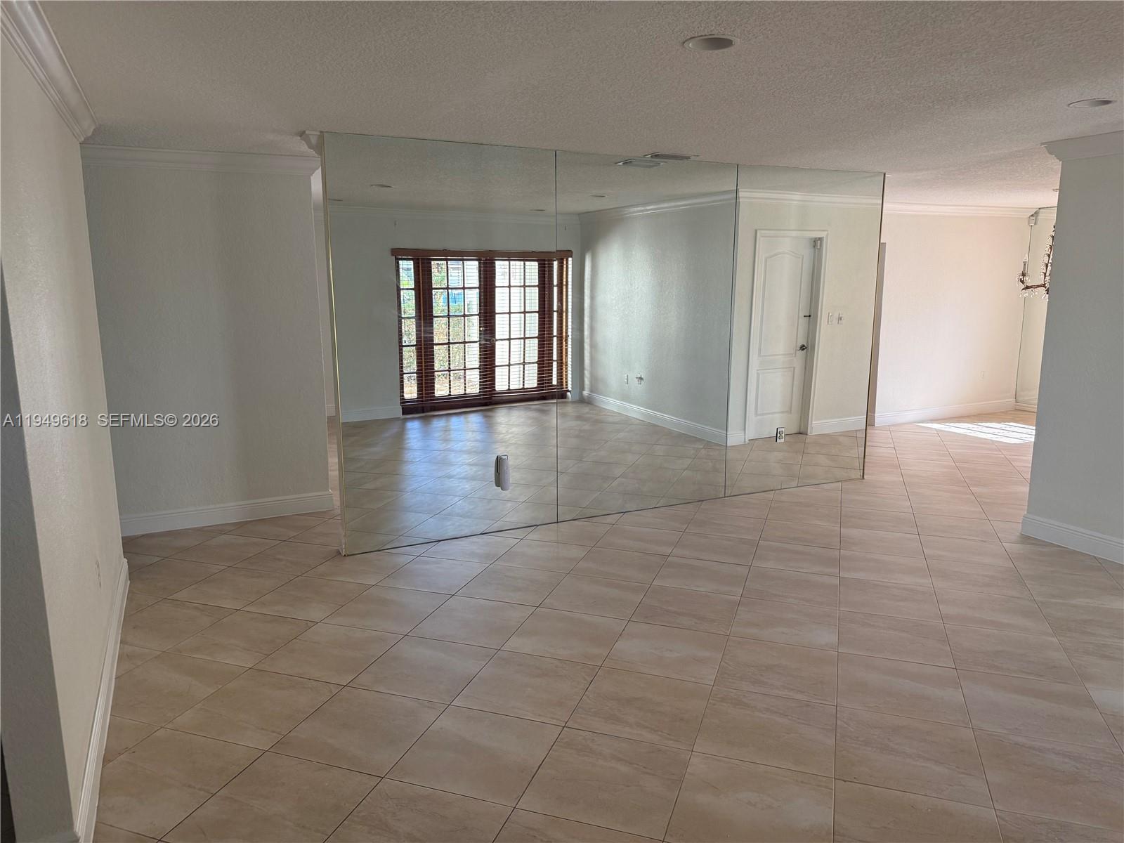 2431 Southwest 124th Avenue Miami, FL 33175 - Photo 7 of 20 a view of livingroom with an empty space and window