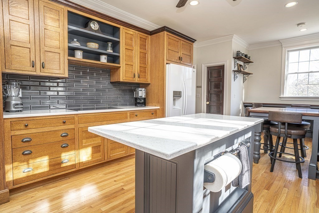 744 Berkley Street Berkley, MA 02779 - Photo 7 of 41 a kitchen with stainless steel appliances kitchen island granite countertop a table chairs in it and a window