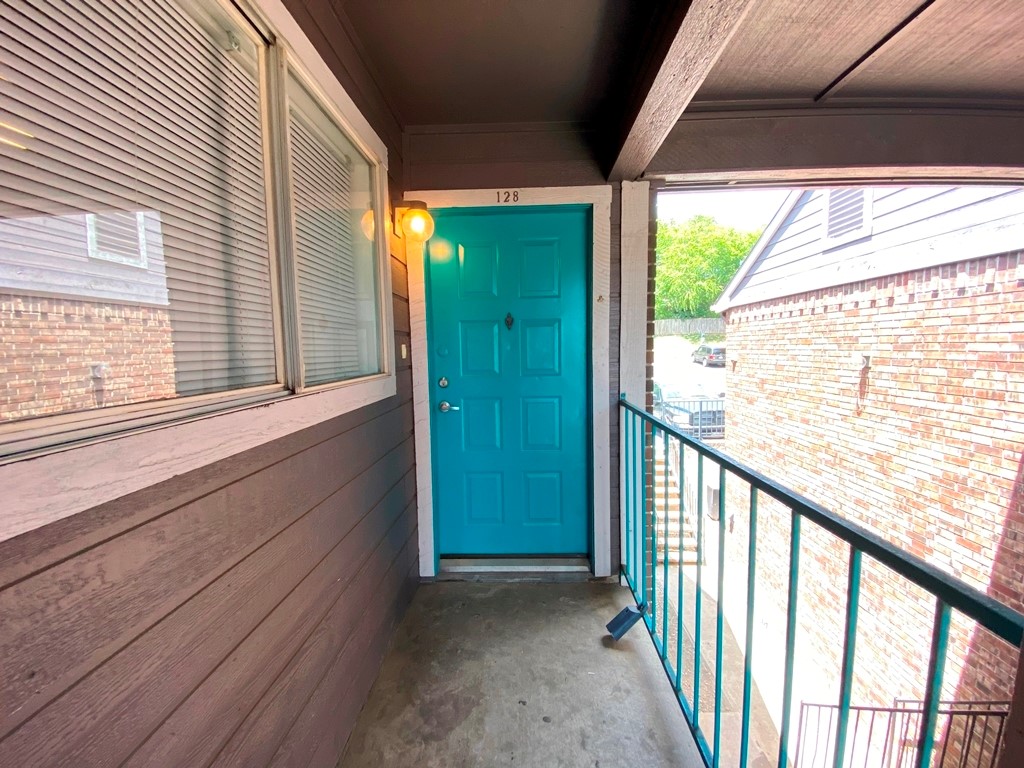 1840 Burton Drive, Unit 128 Austin, TX 78741 - Photo 1 of 22 a view of a porch with wooden floor and stairs
