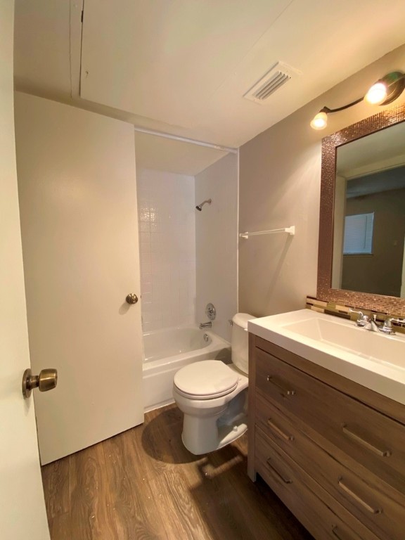1840 Burton Drive, Unit 128 Austin, TX 78741 - Photo 13 of 22 a bathroom with a double vanity sink toilet and a mirror