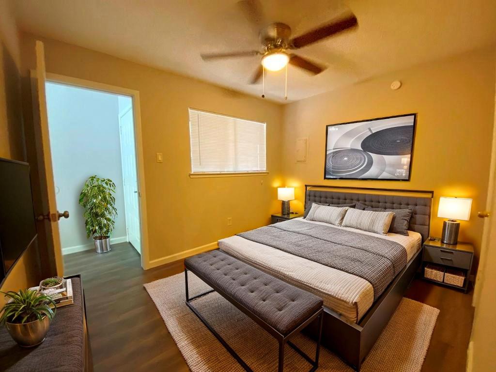 1840 Burton Drive, Unit 128 Austin, TX 78741 - Photo 14 of 22 a bedroom with a bed and a chandelier