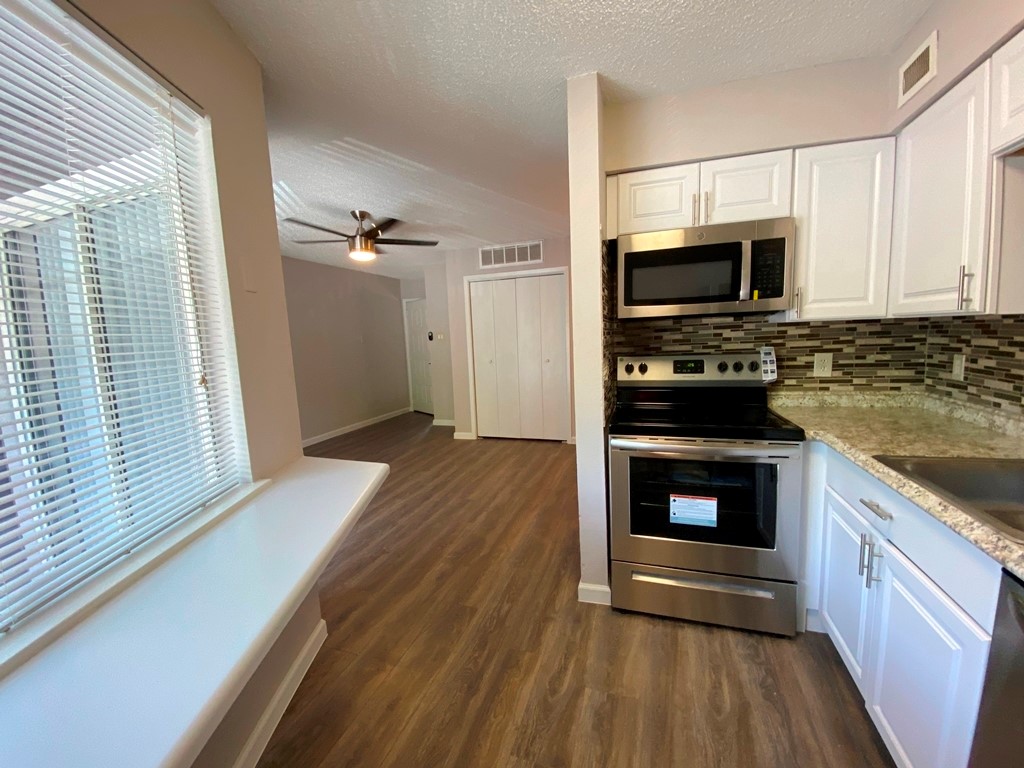 1840 Burton Drive, Unit 128 Austin, TX 78741 - Photo 8 of 22 a view of kitchen with microwave stove refrigerator and oven