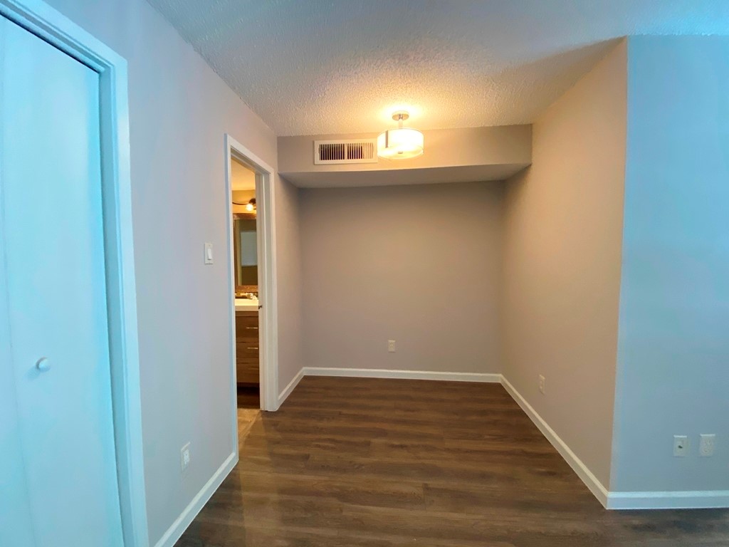 1840 Burton Drive, Unit 128 Austin, TX 78741 - Photo 10 of 22 a view of a room with wooden floor and a window