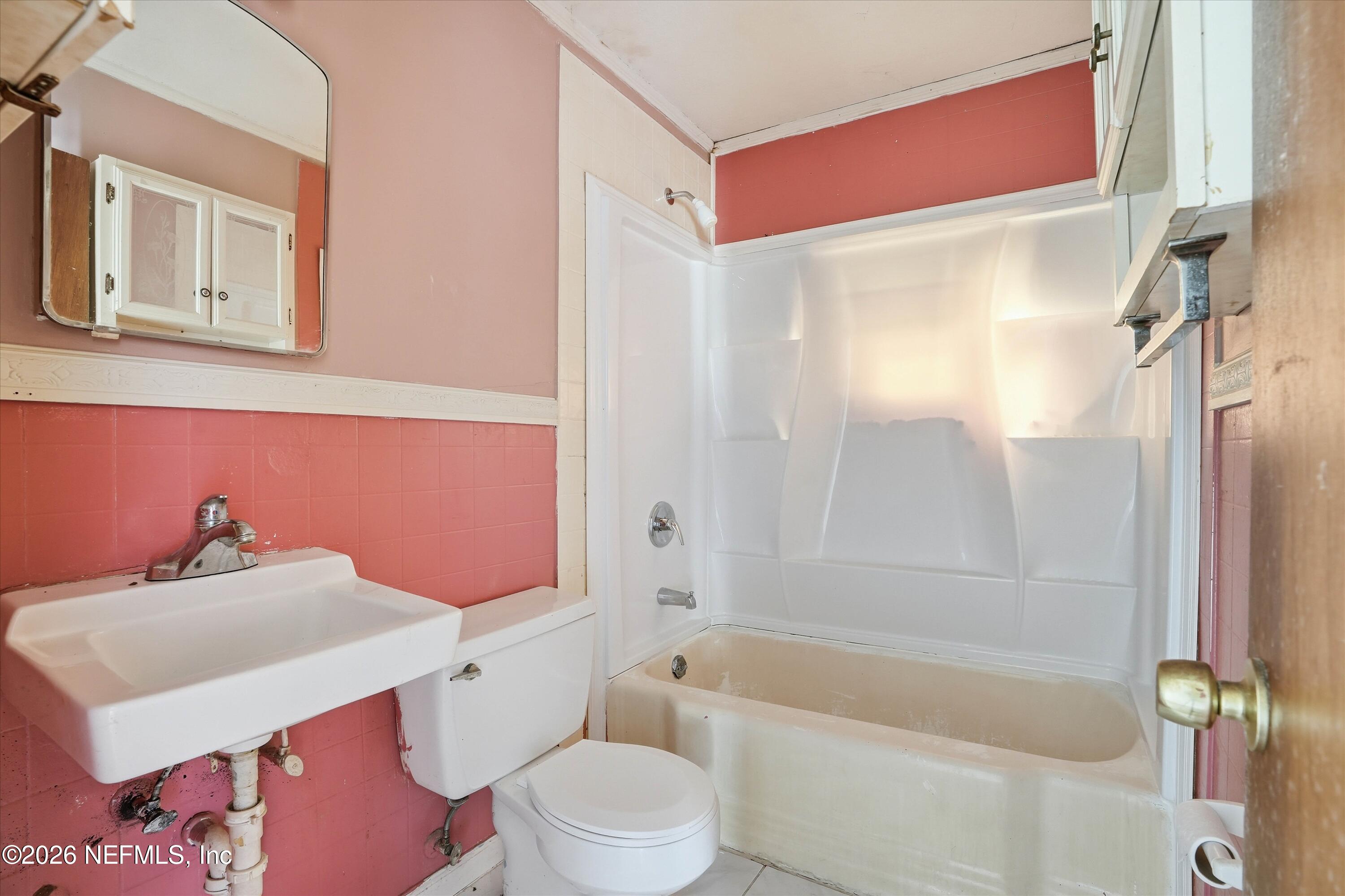 27 Julia Street St. Augustine, FL 32084 - Photo 22 of 46 a bathroom with a sink toilet vanity and shower