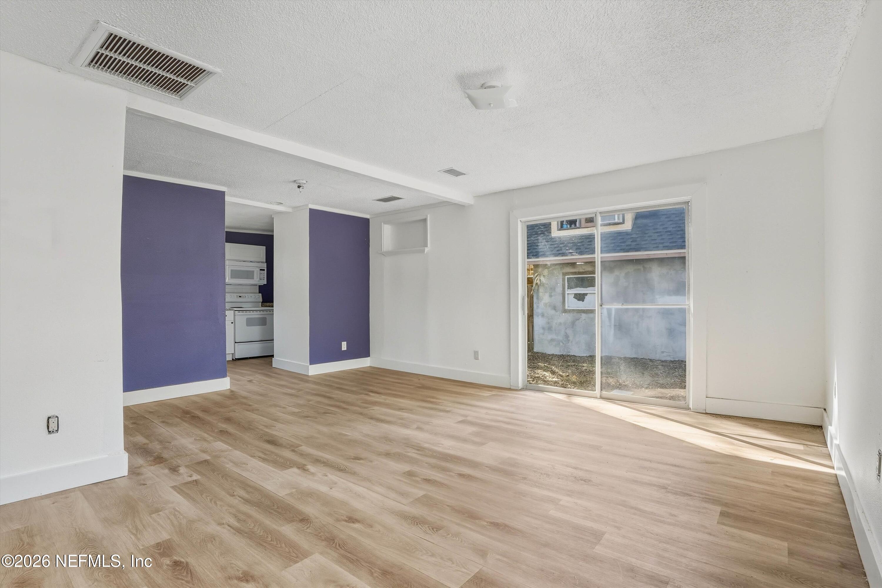 27 Julia Street St. Augustine, FL 32084 - Photo 31 of 46 a view of an empty room with wooden floor and a window