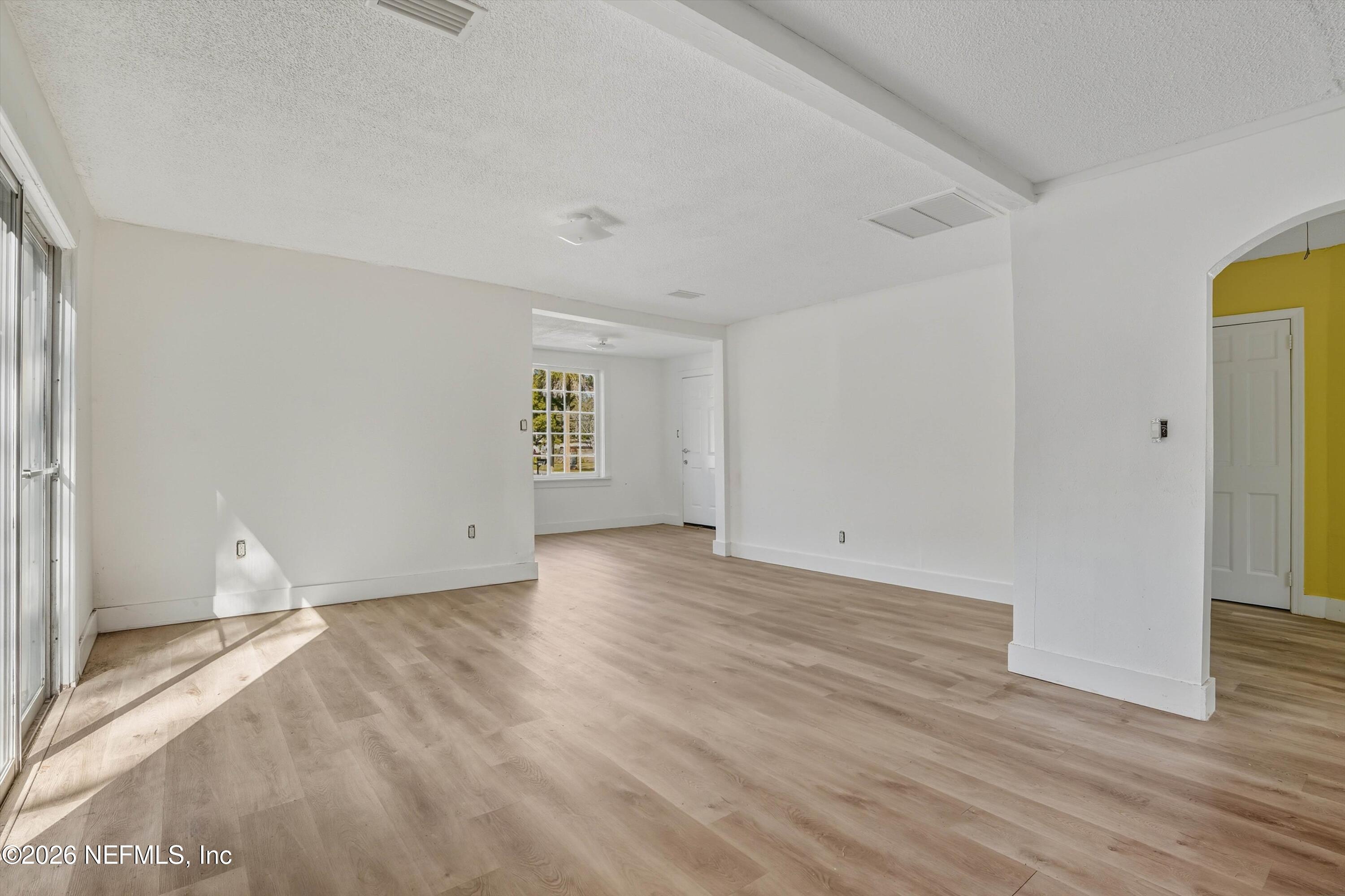 27 Julia Street St. Augustine, FL 32084 - Photo 33 of 46 a view of an empty room with wooden floor and a window