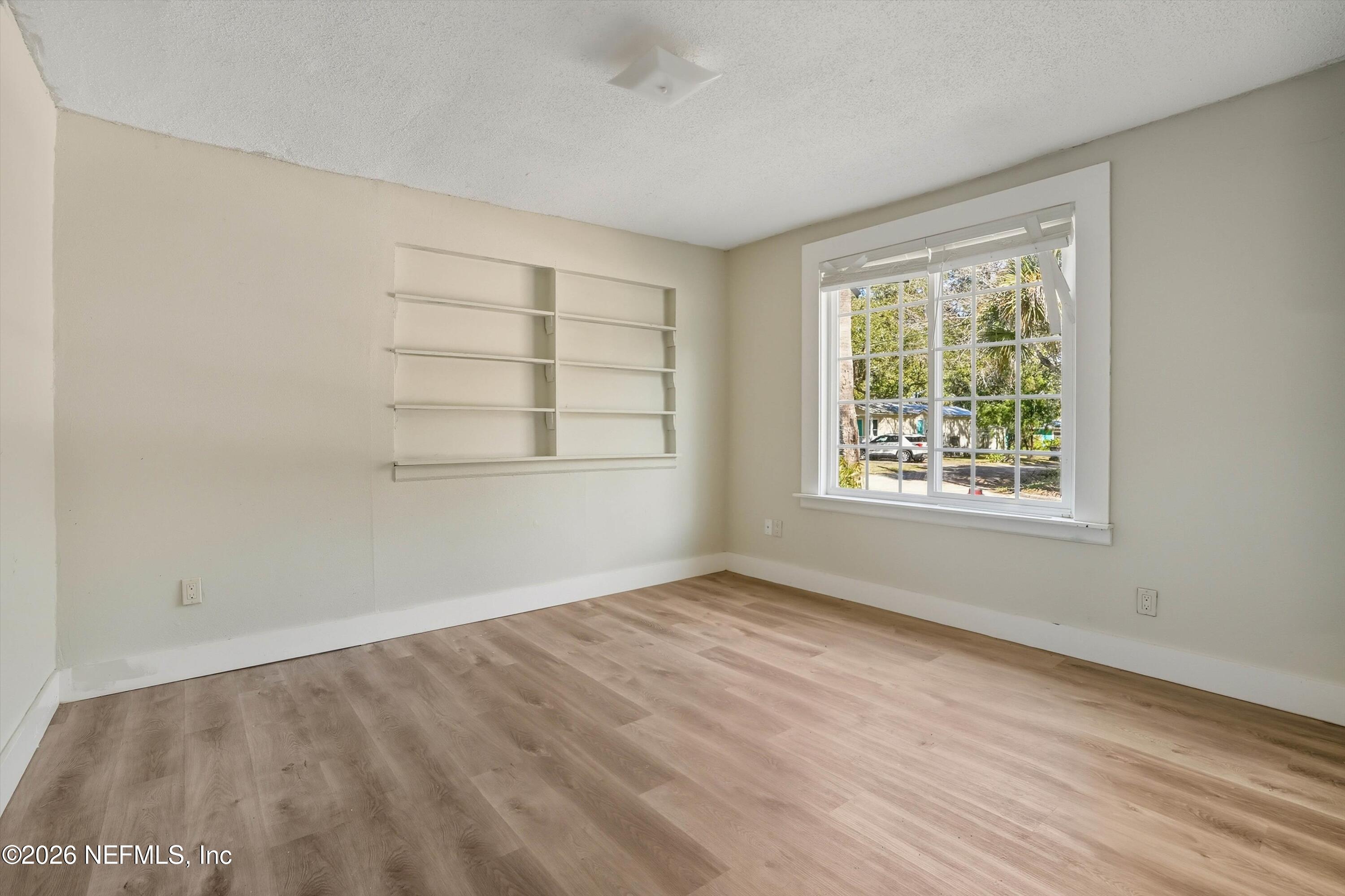 27 Julia Street St. Augustine, FL 32084 - Photo 35 of 46 an empty room with wooden floor and windows
