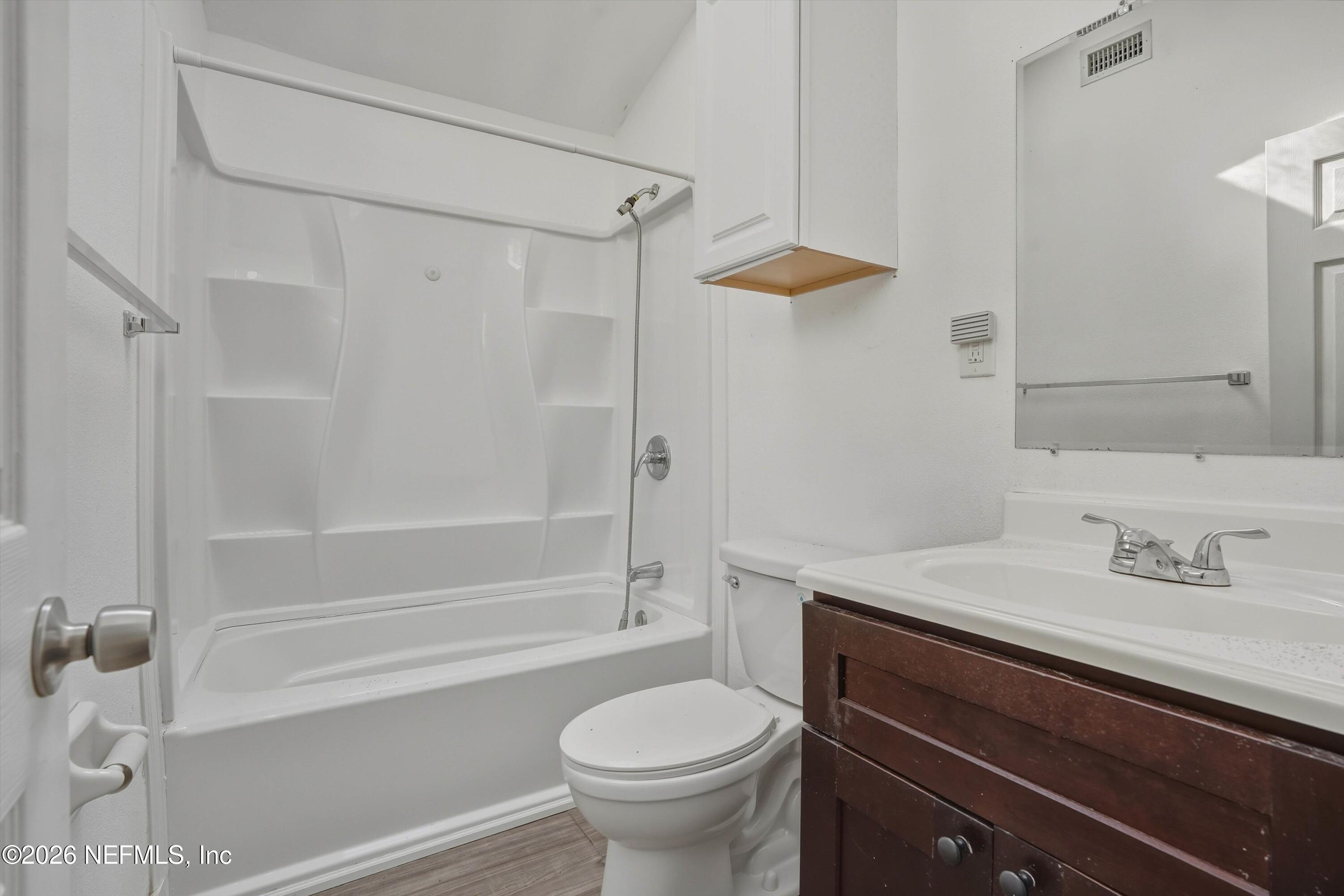 27 Julia Street St. Augustine, FL 32084 - Photo 36 of 46 a bathroom with a sink a toilet and shower