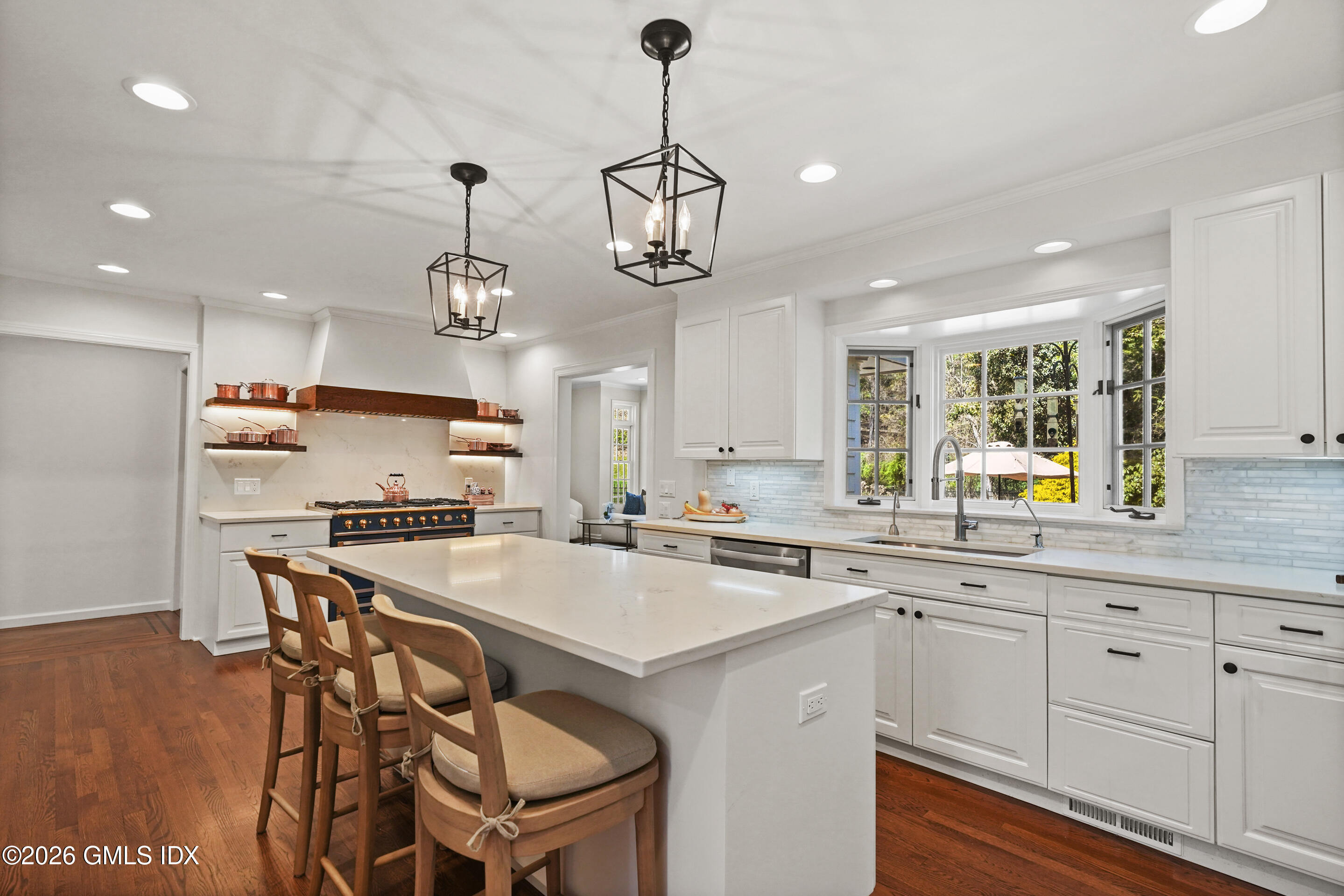 118 Butternut Hollow Road Greenwich, CT 06830 - Photo 12 of 44 a kitchen with a dining table chairs sink and cabinets