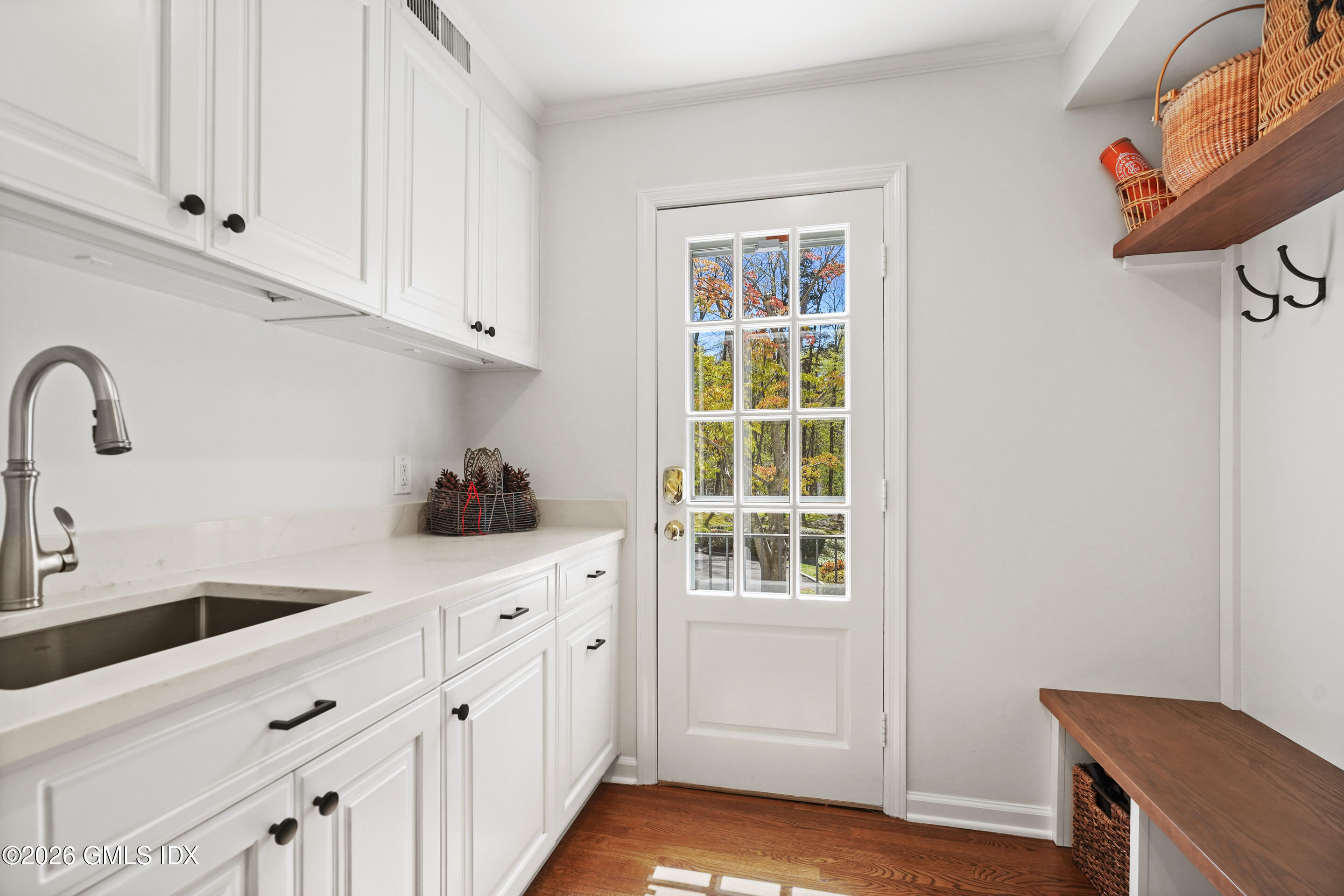 118 Butternut Hollow Road Greenwich, CT 06830 - Photo 18 of 44 a kitchen with white cabinets and sink