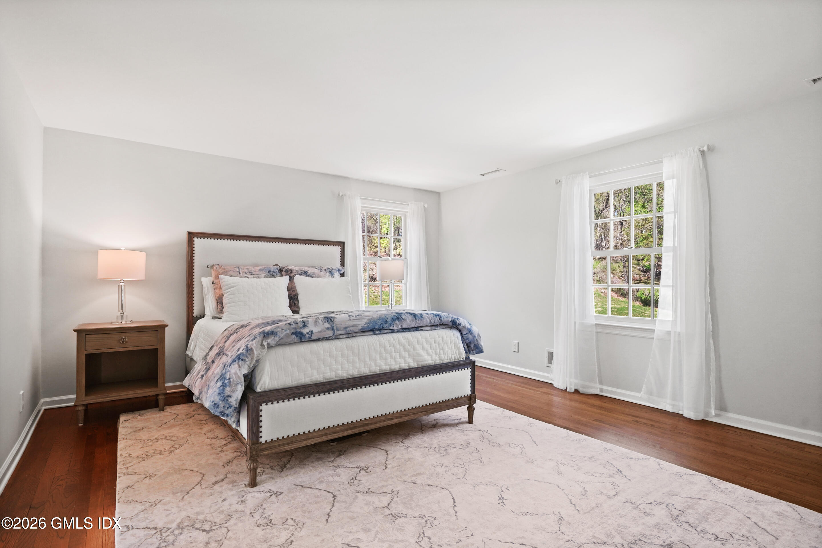 118 Butternut Hollow Road Greenwich, CT 06830 - Photo 21 of 44 a bed sitting in a bedroom next to a window